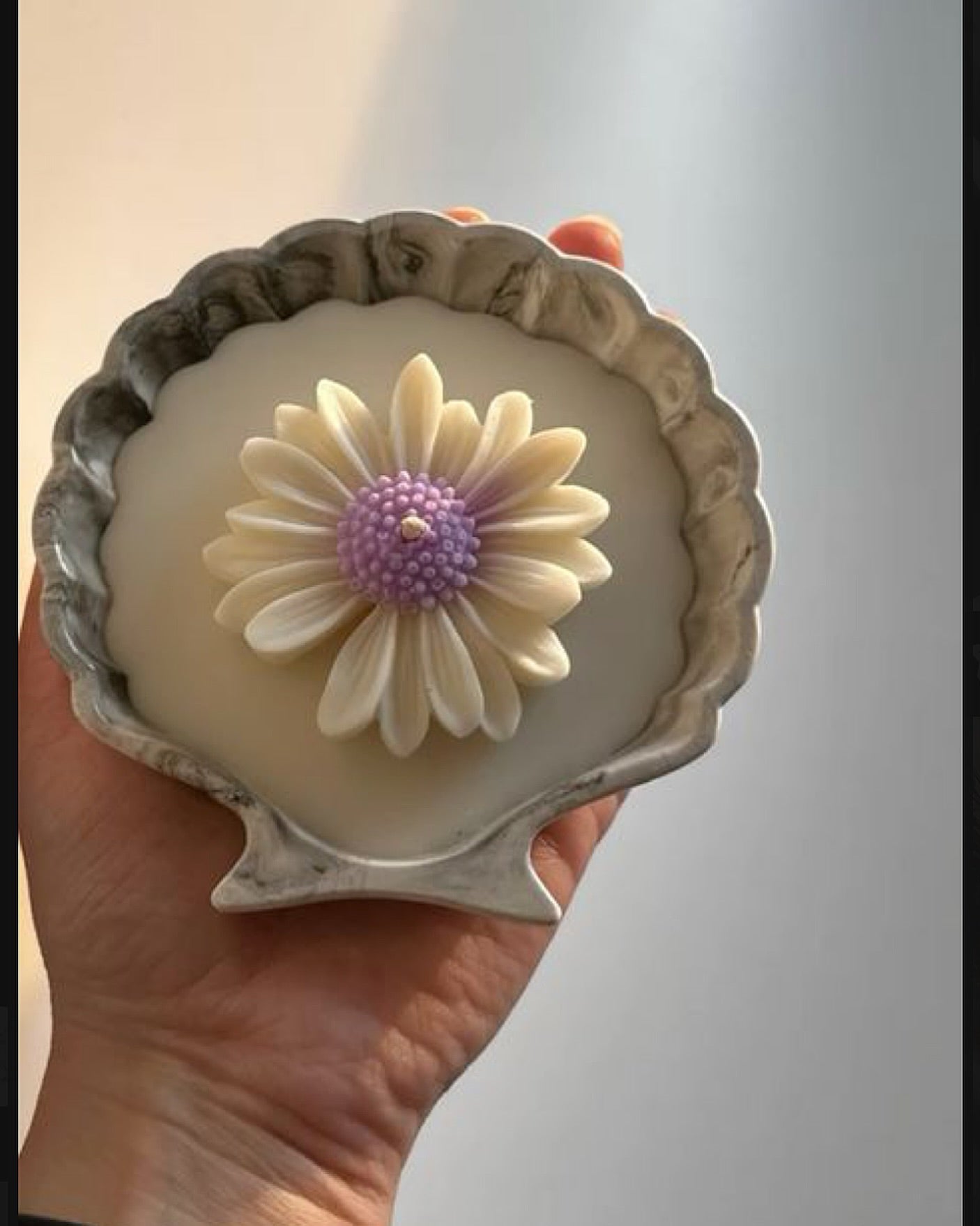 scented candle in a seashell concrete container